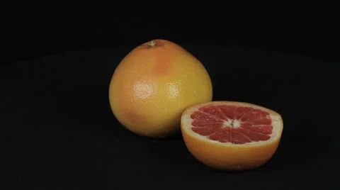 Grapefruit rotates on a black background Stock Footage 35437955