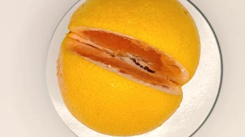 Grapefruit rotating close-up white background top view Video stock 331887605