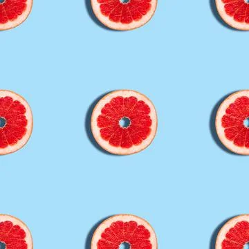 Grapefruit seamless pattern on a blue background.  Stock Photos