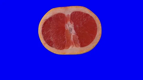 Grapefruit slice spin 360 degrees isolated on blue screen Stock Footage 144533759