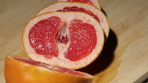 Grapefruit sliced on a bamboo board Stock Footage 146147446