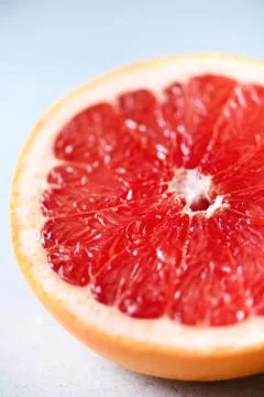 Grapefruit sliced half on grey background. Citrus fruit macro. Copy space, top Stock Photos
