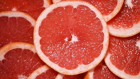 Grapefruit sliced half on rotating background. Citrus fruits. Vegan and raw food Stock Footage 125417867