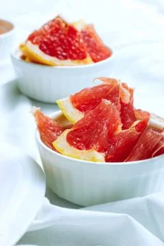 Grapefruit slices on light background Stock Photos