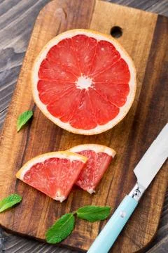 Grapefruit with slices on a table. Stock Photos