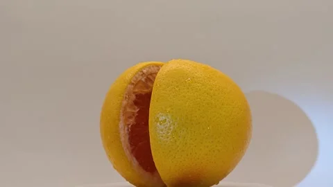 The grapefruit spins, casting shadows. Stock Footage 331887911