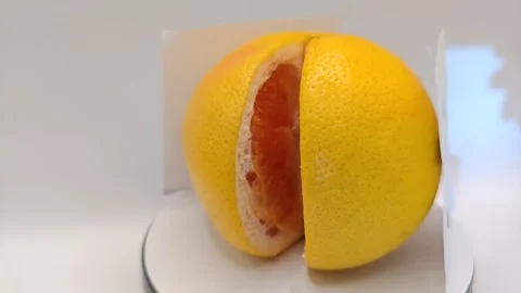 The grapefruit spins large and has a smiley face. Stock-Footage 331887221