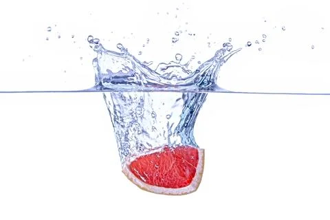 Grapefruit Wedge Splash Stock Photos