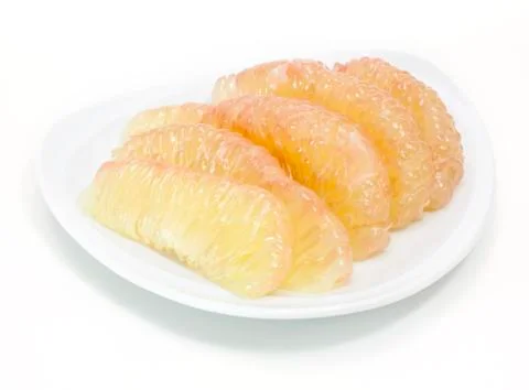 Grapefruit on white plate Stock Photos