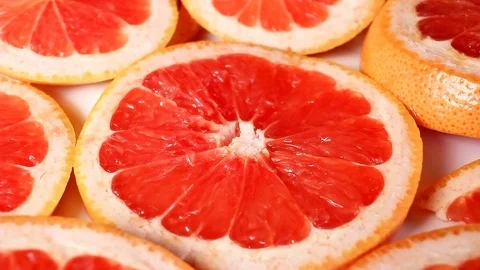 Grapefruits. Grapefruit slices rotating pattern macro texture background Stock Footage 91379153