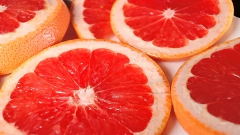 Grapefruits. Grapefruit slices rotating pattern macro texture background Stock Footage 91379155