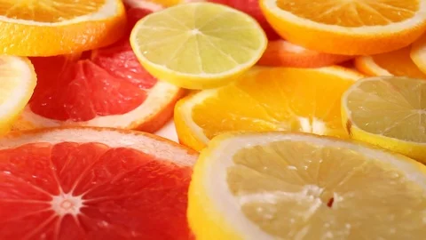 Grapefruits. Grapefruit slices rotating pattern macro texture background Stock Footage 91379282