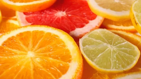 Grapefruits. Grapefruit slices rotating pattern macro texture background Stock Footage 91379342
