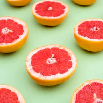Grapefruits on green background Stock Photos