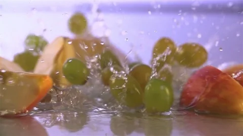 Grapes and Apple  falling in water Stock Footage 76437188