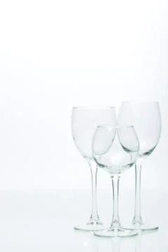 Grapes and three glasses for wine on a white background, studio light Stock Photos