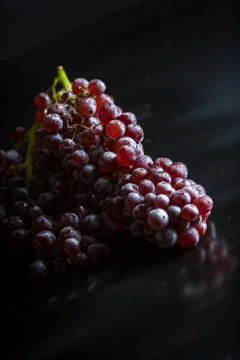 Grapes on black reflective background Stock Photos