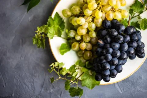 Grapes on the ceramic plate Stock Photos