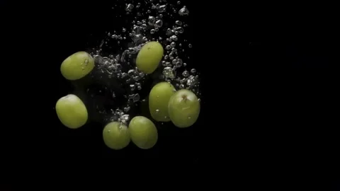 Grapes Dropped into Water Stock Footage 146569554