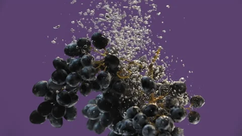 The grapes fall into the water, the splashes and bubbles are beautiful Stock Footage 146637683