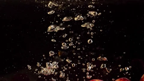 A grapes falling into the water with air bubbles. On a black background. Stock Footage 148053131