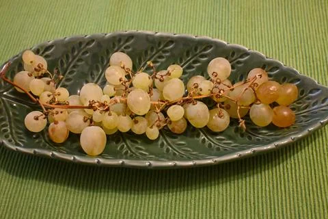 Grapes on a grape leaf shaped plate Stock Photos