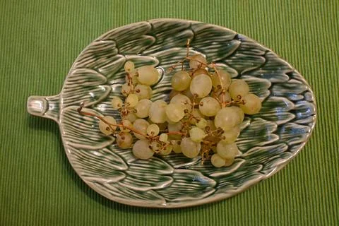 Grapes on a grape leaf shaped serving plate Stock Photos
