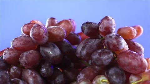 Grapes isolated rotating on blue background Video stock 62414293