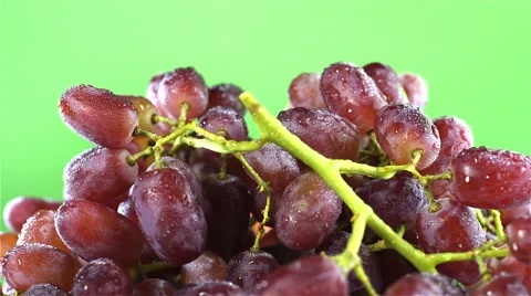 Grapes isolated rotating on green background Stock Footage 62414646