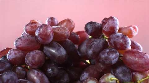 Grapes isolated rotating on red/pink background Stock Footage 62413851
