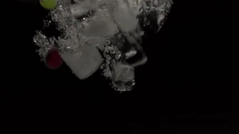 Grapes with lime will fall into the water in slow motion. on a black backgro Stock Footage 131036765