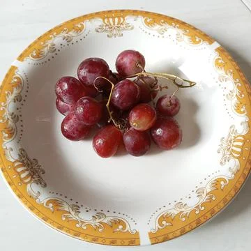 Grapes on the plate Stock Photos