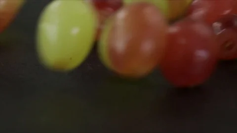 Grapes Roll over Black Slate Closeup Stock Footage 99165510