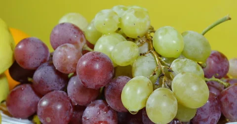 Grapes on table close up, dolly shot, other fruits on plates around . Stock Footage 60756968