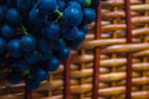 Grapes on a wicker background. Stock Photos