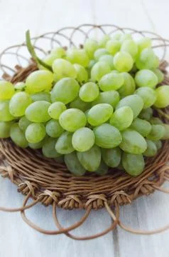 Grapes in a wicker plate Stock Photos