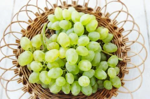 Grapes in a wicker plate Stock Photos