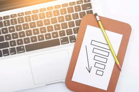 Graph with arrow down on the paper 写真素材