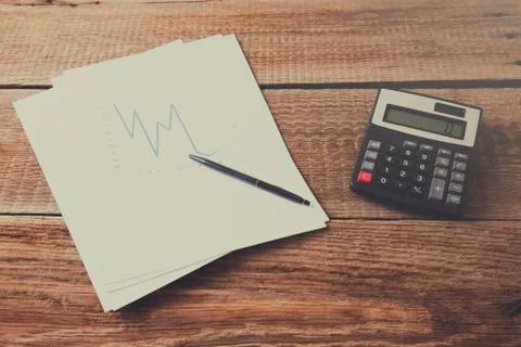 Graph with calculator on desk Stock Photos