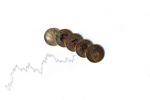 Graph of changes in exchange rates and bitcoin coins on a white background. I Stock Photos