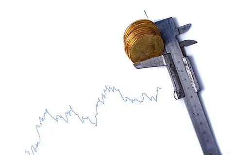 Graph of changes in exchange rates and bitcoin coins on a white background. I Stock Photos