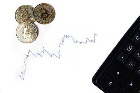 Graph of changes in exchange rates, calculator and bitcoin coins on a white b Stock Photos