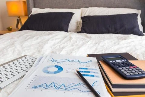Graph chart report in bedroom, work at home. Stock Photos