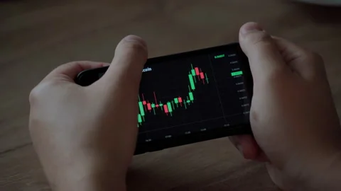 Graph of crypto currency online. Man holding smartphone. Stock exchange market Stock Footage 157285156