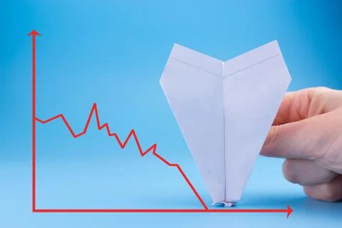 Graph going down behind the plane crash Foto stock