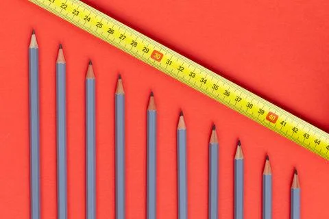 A graph going down. Grey sharpened pencils symbolizing a downward trend.  Stock Photos