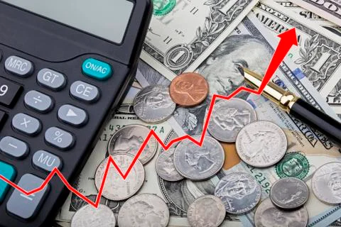 Graph showing USD bank notes with coins and a calculator Stock Photos
