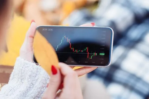 Graph on the stock exchange in red and green colors on the phone. Stock Photos