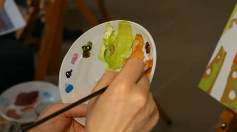 Graphic artist mixing oils color paints in palette Stock Footage 59658875