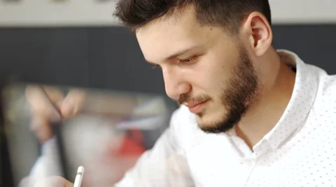 Graphic artist using graphics tablet at his desk 20s 4k Stock Footage 68867923